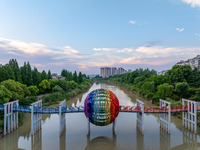 A photo is showing the North-South Geographical Boundary indication Garden in the Chaoxia district of Huai'an City, Jiangsu province, China,...