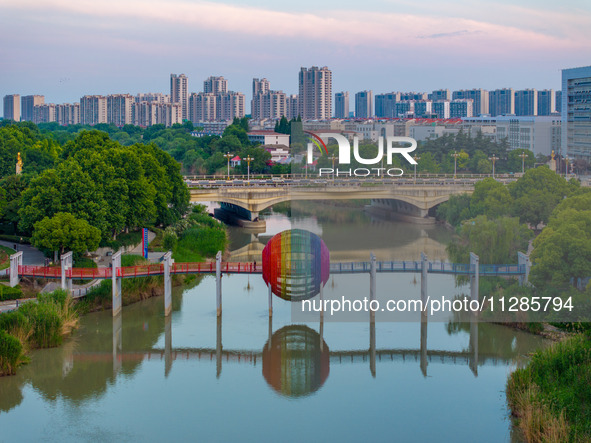 A photo is showing the North-South Geographical Boundary indication Garden in the Chaoxia district of Huai'an City, Jiangsu province, China,...