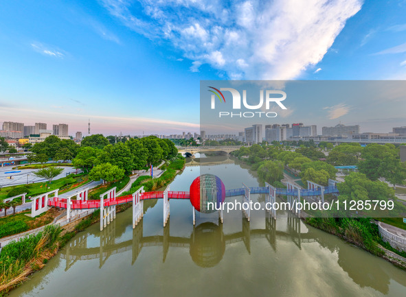 A photo is showing the North-South Geographical Boundary indication Garden in the Chaoxia district of Huai'an City, Jiangsu province, China,...