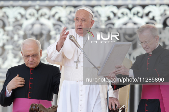 Pope Francis is blessing the crowd at the end of his Wednesday general audience in St. Peter's Square at the Vatican, on May 29, 2024. 