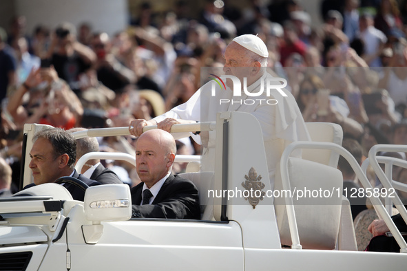 Pope Francis is greeting the faithful as he arrives to lead his Wednesday general audience in St. Peter's Square at the Vatican, on May 29,...