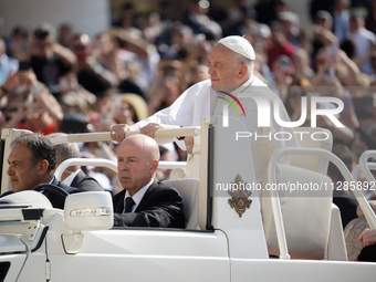 Pope Francis is greeting the faithful as he arrives to lead his Wednesday general audience in St. Peter's Square at the Vatican, on May 29,...