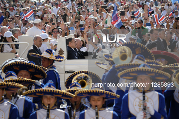 Pope Francis is greeting the faithful as he is arriving to lead his Wednesday general audience in St Peter's Square at the Vatican, on May 2...