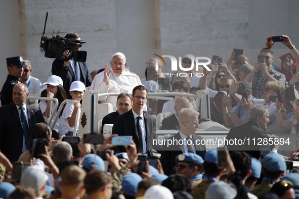 Pope Francis is greeting the faithful as he arrives to lead his Wednesday general audience in St. Peter's Square at the Vatican, on May 29,...