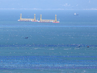 Fishermen are driving a breeding boat to carry out ecological farming work on the sea surface at a Marine ranch in Dinghai Bay in Fuzhou, Fu...