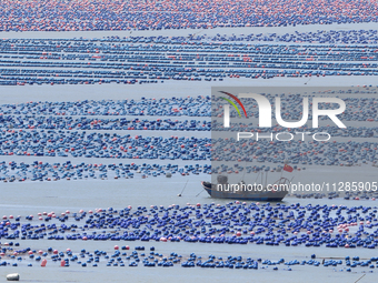 Fishermen are driving a breeding boat to carry out ecological farming work on the sea surface at a Marine ranch in Dinghai Bay in Fuzhou, Fu...