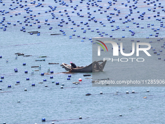 Fishermen are driving a breeding boat to carry out ecological farming work on the sea surface at a Marine ranch in Dinghai Bay in Fuzhou, Fu...