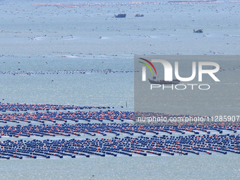 Fishermen are driving a breeding boat to carry out ecological farming work on the sea surface at a Marine ranch in Dinghai Bay in Fuzhou, Fu...