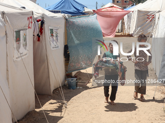 Displaced Palestinians are being seen among the tents in Deir el-Balah in the central Gaza Strip on May 29, 2024, amid the ongoing conflict...