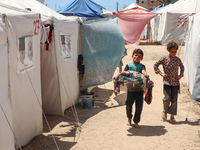 Displaced Palestinians are being seen among the tents in Deir el-Balah in the central Gaza Strip on May 29, 2024, amid the ongoing conflict...