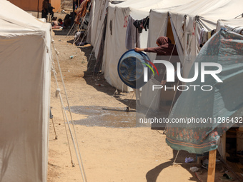 Displaced Palestinians are being seen among the tents in Deir el-Balah in the central Gaza Strip on May 29, 2024, amid the ongoing conflict...