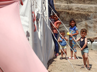 Displaced Palestinians are being seen among the tents in Deir el-Balah in the central Gaza Strip on May 29, 2024, amid the ongoing conflict...