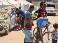 A vendor is selling ice cream at a camp for displaced Palestinians in Deir el-Balah in the central Gaza Strip on May 29, 2024, amid the ongo...