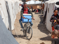 A vendor is selling ice cream at a camp for displaced Palestinians in Deir el-Balah in the central Gaza Strip on May 29, 2024, amid the ongo...