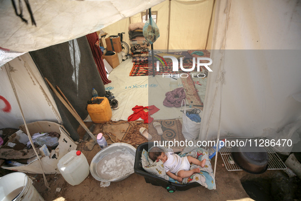 Displaced Palestinians are being seen among the tents in Deir el-Balah in the central Gaza Strip on May 29, 2024, amid the ongoing conflict...