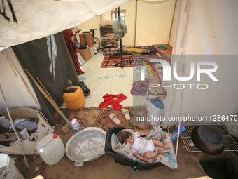 Displaced Palestinians are being seen among the tents in Deir el-Balah in the central Gaza Strip on May 29, 2024, amid the ongoing conflict...