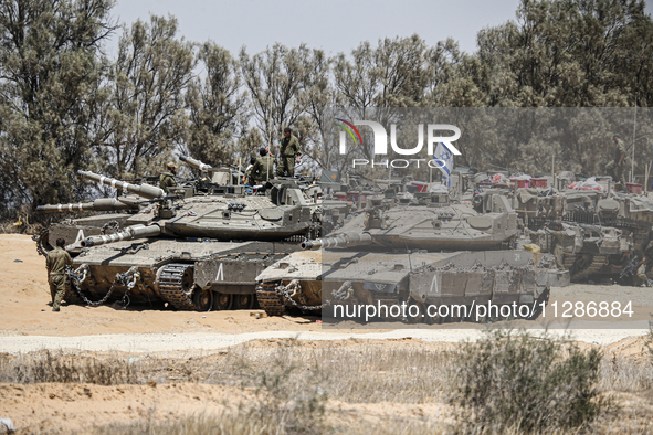 The Israeli Army is mobilizing tanks, armored personnel carriers, trucks, and military jeeps on the border line near the city of Rafah, Gaza...