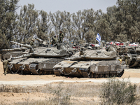 The Israeli Army is mobilizing tanks, armored personnel carriers, trucks, and military jeeps on the border line near the city of Rafah, Gaza...