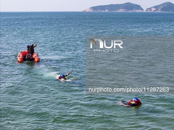 Rescuers are conducting a training to rescue drowning at sea in Yantai, China, on May 29, 2024. 