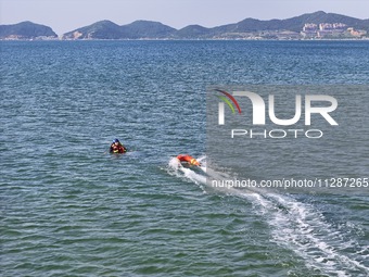 Rescuers are conducting a training to rescue drowning at sea in Yantai, China, on May 29, 2024. (