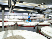 A worker is performing textile work at a textile workshop of a textile company in Aksu prefecture, Northwest China's Xinjiang Uygur autonomo...