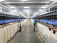 Workers are performing textile work at a textile workshop of a textile company in Aksu prefecture, Northwest China's Xinjiang Uygur autonomo...