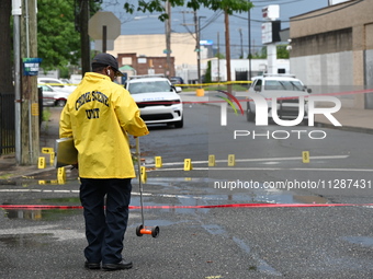 The Philadelphia Police Crime Scene Unit is placing evidence markers at the crime scene and taking photographs of the scene while investigat...