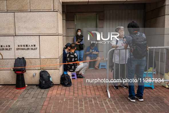 People are waiting outside the courthouse to hear the verdict of the trial of the 47 pro-democracy figures in Hong Kong, on May 30, 2024. Th...