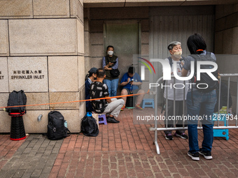 People are waiting outside the courthouse to hear the verdict of the trial of the 47 pro-democracy figures in Hong Kong, on May 30, 2024. Th...