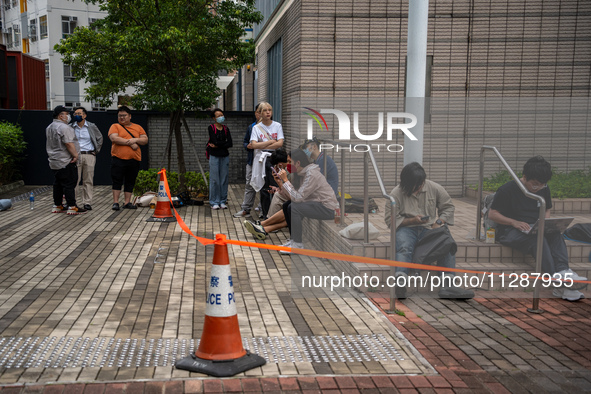 People are waiting outside the courthouse to hear the verdict of the trial of the 47 pro-democracy figures in Hong Kong, on May 30, 2024. Th...