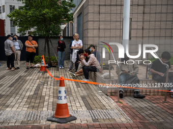 People are waiting outside the courthouse to hear the verdict of the trial of the 47 pro-democracy figures in Hong Kong, on May 30, 2024. Th...