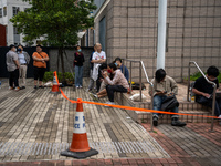 People are waiting outside the courthouse to hear the verdict of the trial of the 47 pro-democracy figures in Hong Kong, on May 30, 2024. Th...