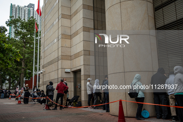 People are waiting outside the courthouse to hear the verdict of the trial of the 47 pro-democracy figures in Hong Kong, on May 30, 2024. Th...