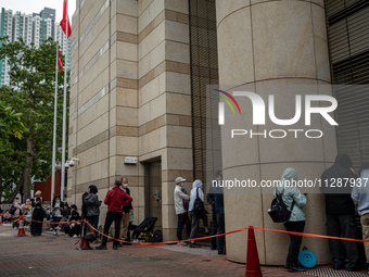 People are waiting outside the courthouse to hear the verdict of the trial of the 47 pro-democracy figures in Hong Kong, on May 30, 2024. Th...