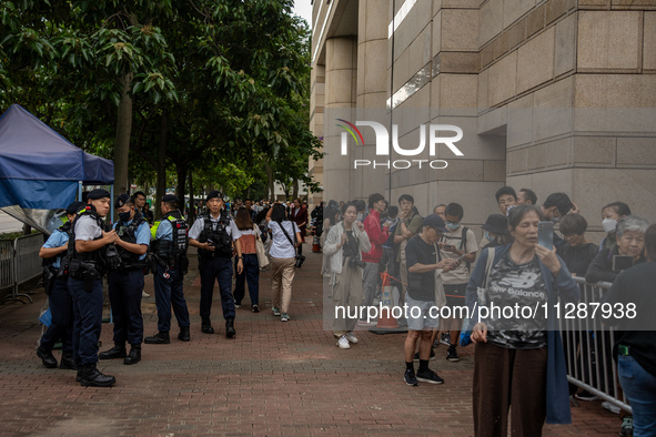 People are waiting outside the courthouse to hear the verdict of the trial of the 47 pro-democracy figures in Hong Kong, on May 30, 2024. Th...