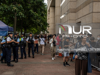 People are waiting outside the courthouse to hear the verdict of the trial of the 47 pro-democracy figures in Hong Kong, on May 30, 2024. Th...