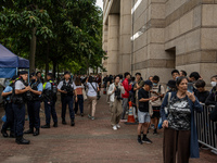 People are waiting outside the courthouse to hear the verdict of the trial of the 47 pro-democracy figures in Hong Kong, on May 30, 2024. Th...