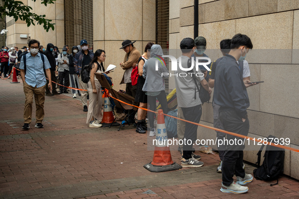 People are waiting outside the courthouse to hear the verdict of the trial of the 47 pro-democracy figures in Hong Kong, on May 30, 2024. Th...