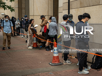 People are waiting outside the courthouse to hear the verdict of the trial of the 47 pro-democracy figures in Hong Kong, on May 30, 2024. Th...