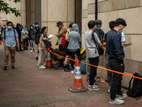 People are waiting outside the courthouse to hear the verdict of the trial of the 47 pro-democracy figures in Hong Kong, on May 30, 2024. Th...