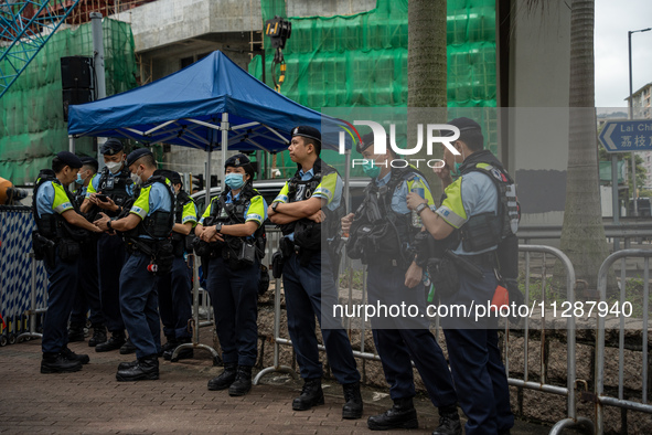 Police officers are standing outside the courthouse to hear the verdict of the trial of the 47 pro-democracy figures in Hong Kong, China, on...