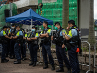 Police officers are standing outside the courthouse to hear the verdict of the trial of the 47 pro-democracy figures in Hong Kong, China, on...