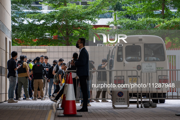 Protesters are being escorted onto a police van at the courthouse where the verdict of the trial of the 47 pro-democracy figures is being ha...