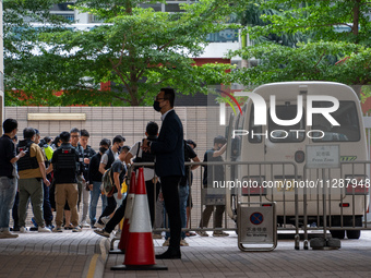 Protesters are being escorted onto a police van at the courthouse where the verdict of the trial of the 47 pro-democracy figures is being ha...