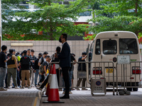 Protesters are being escorted onto a police van at the courthouse where the verdict of the trial of the 47 pro-democracy figures is being ha...