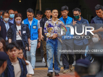 Lee Yue-shun (centre) is leaving the court building after being acquitted, in Hong Kong, China, on May 30, 2024. (