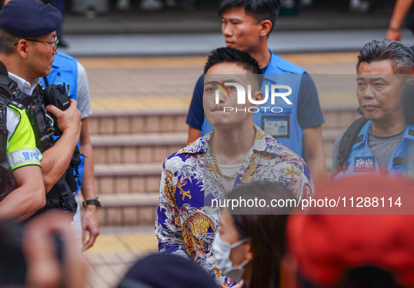 Lee Yue-shun (centre) is leaving the court building after being acquitted, in Hong Kong, China, on May 30, 2024. 