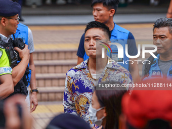 Lee Yue-shun (centre) is leaving the court building after being acquitted, in Hong Kong, China, on May 30, 2024. (