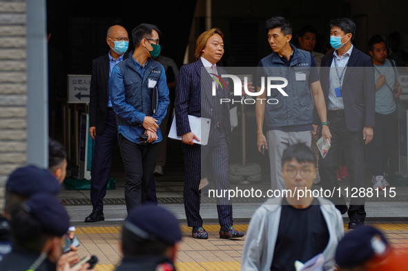 Lawrence Lau (centre) is leaving the court building after being acquitted, in Hong Kong, China, on May 30, 2024. 