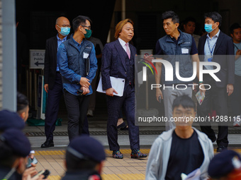 Lawrence Lau (centre) is leaving the court building after being acquitted, in Hong Kong, China, on May 30, 2024. (